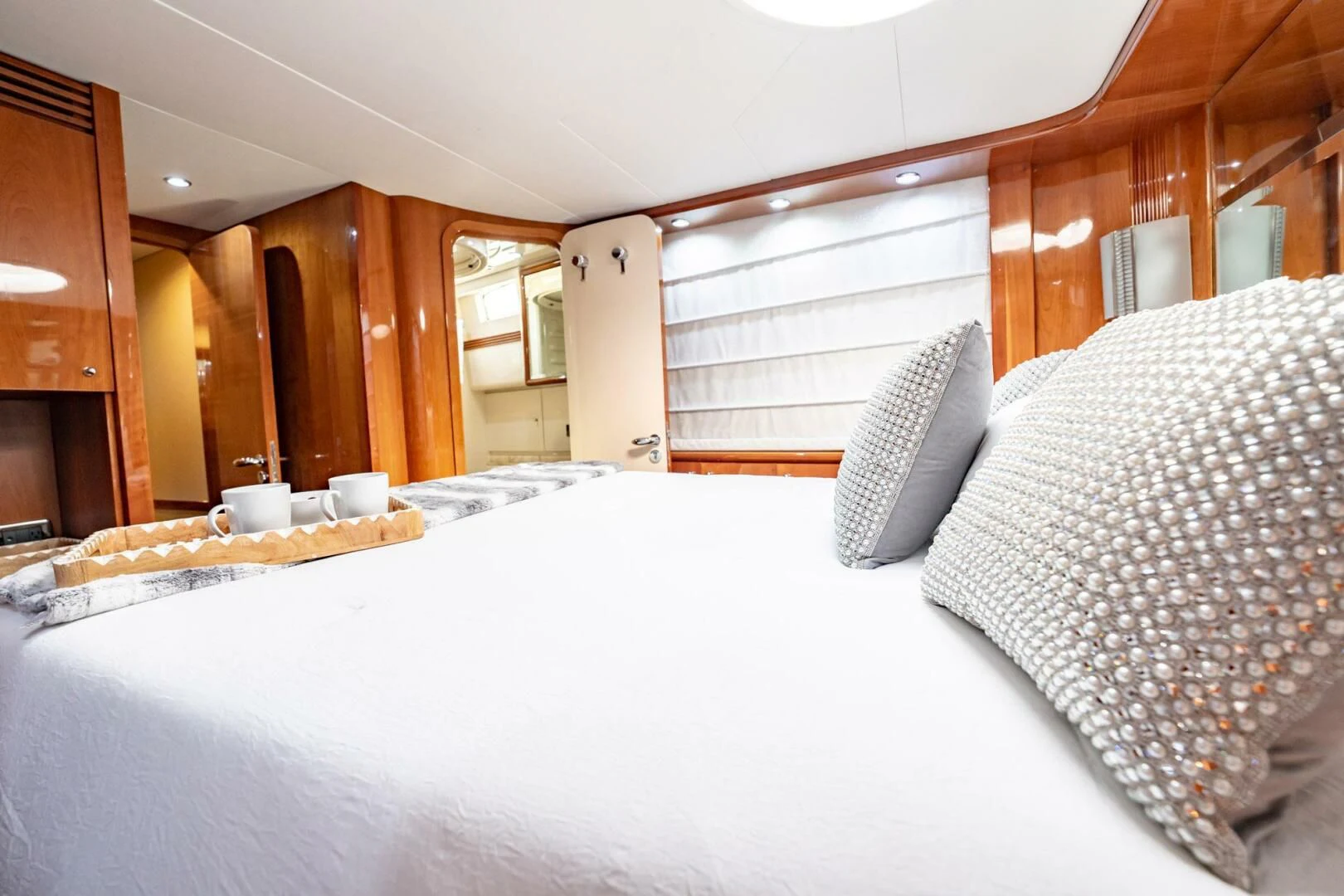 a bed with pillows on it aboard THE CURE Yacht for Sale