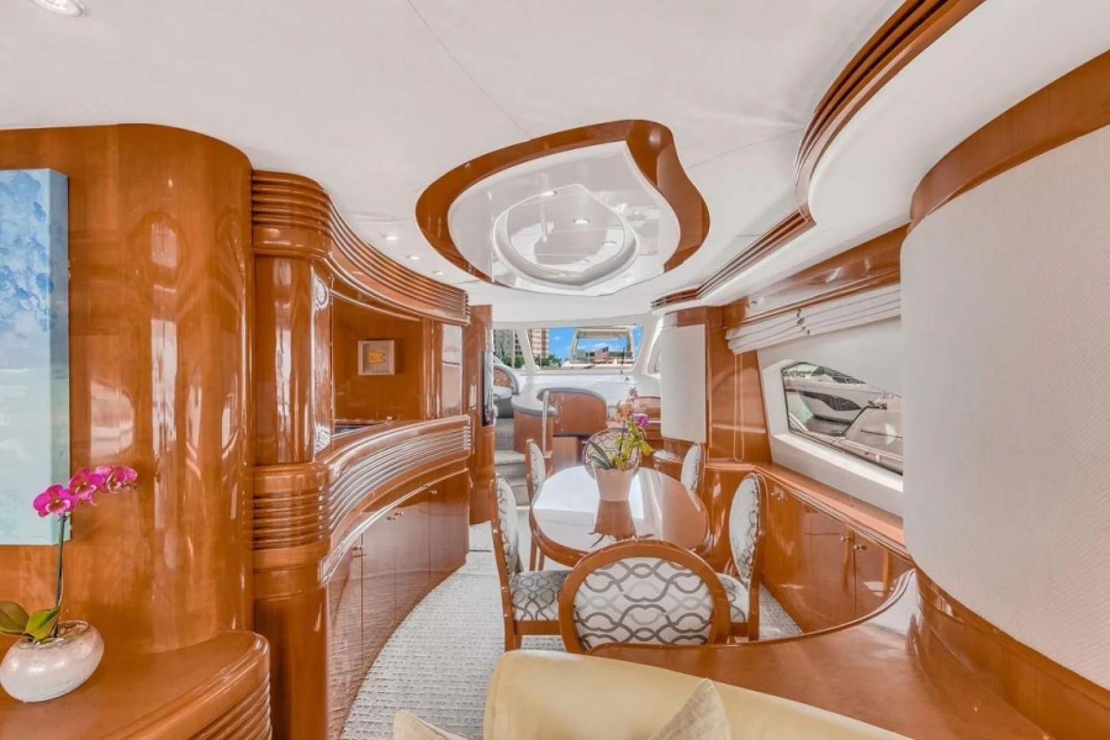 a room with a table chairs and a bed aboard THE CURE Yacht for Sale