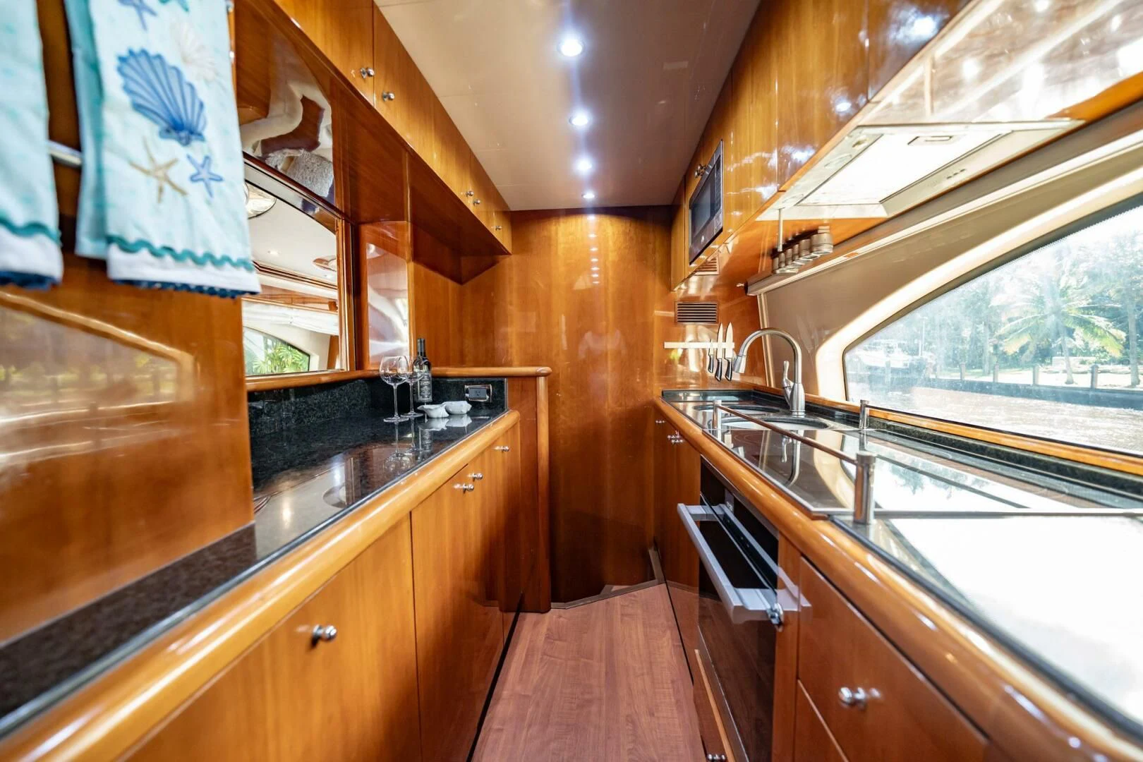 a kitchen with wooden cabinets aboard THE CURE Yacht for Sale