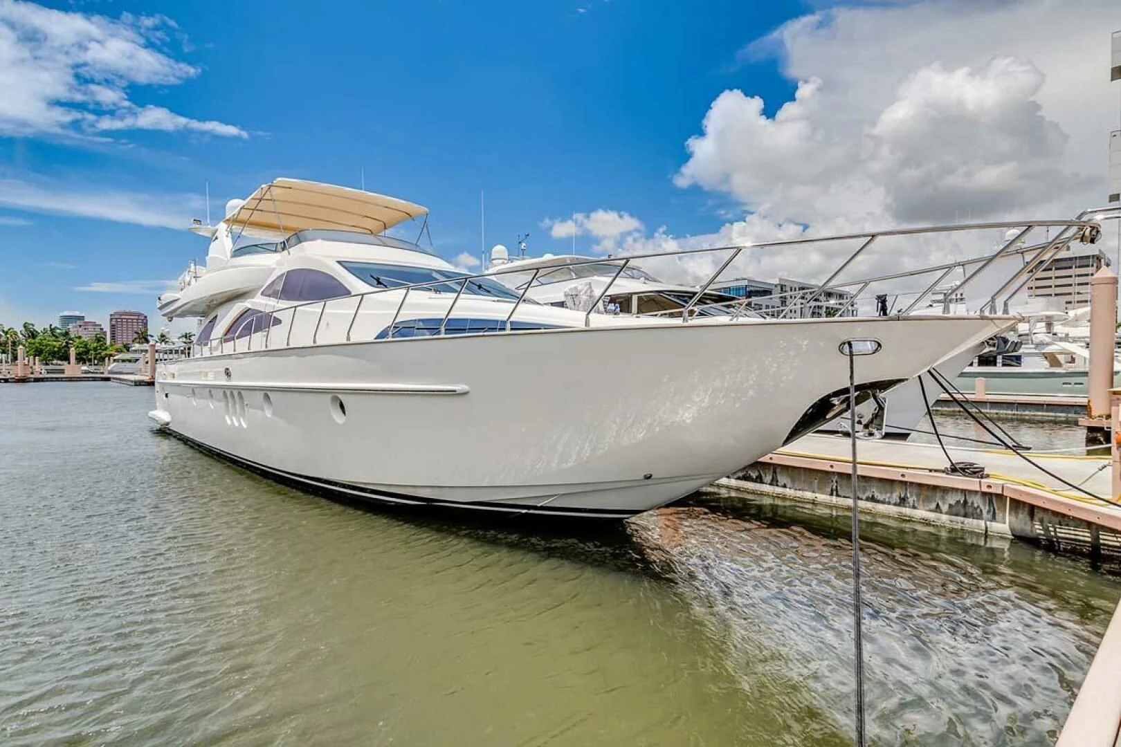 a white boat docked aboard THE CURE Yacht for Sale