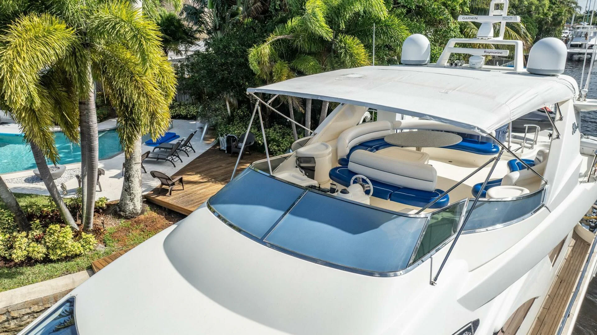 a white boat on a dock aboard THE CURE Yacht for Sale