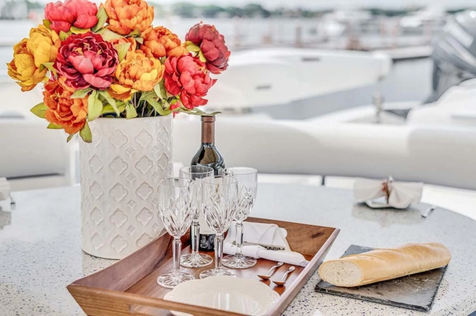 a table with wine glasses and flowers aboard THE CURE Yacht for Sale