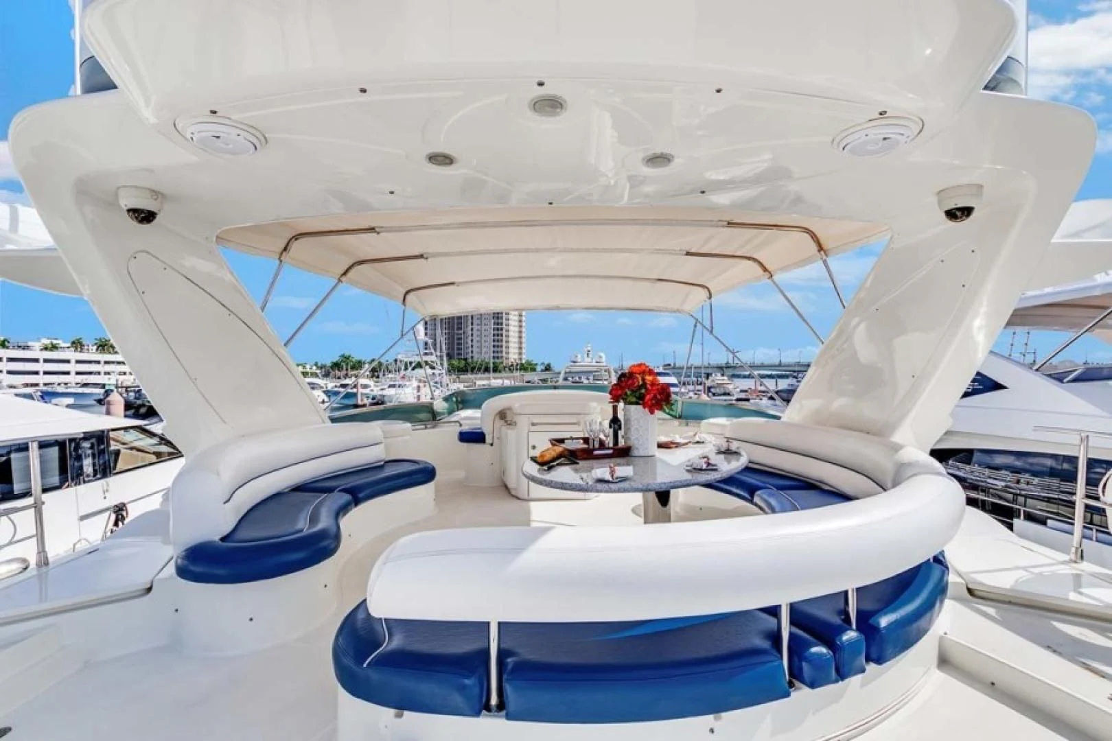 a white boat with a table and chairs on it aboard THE CURE Yacht for Sale