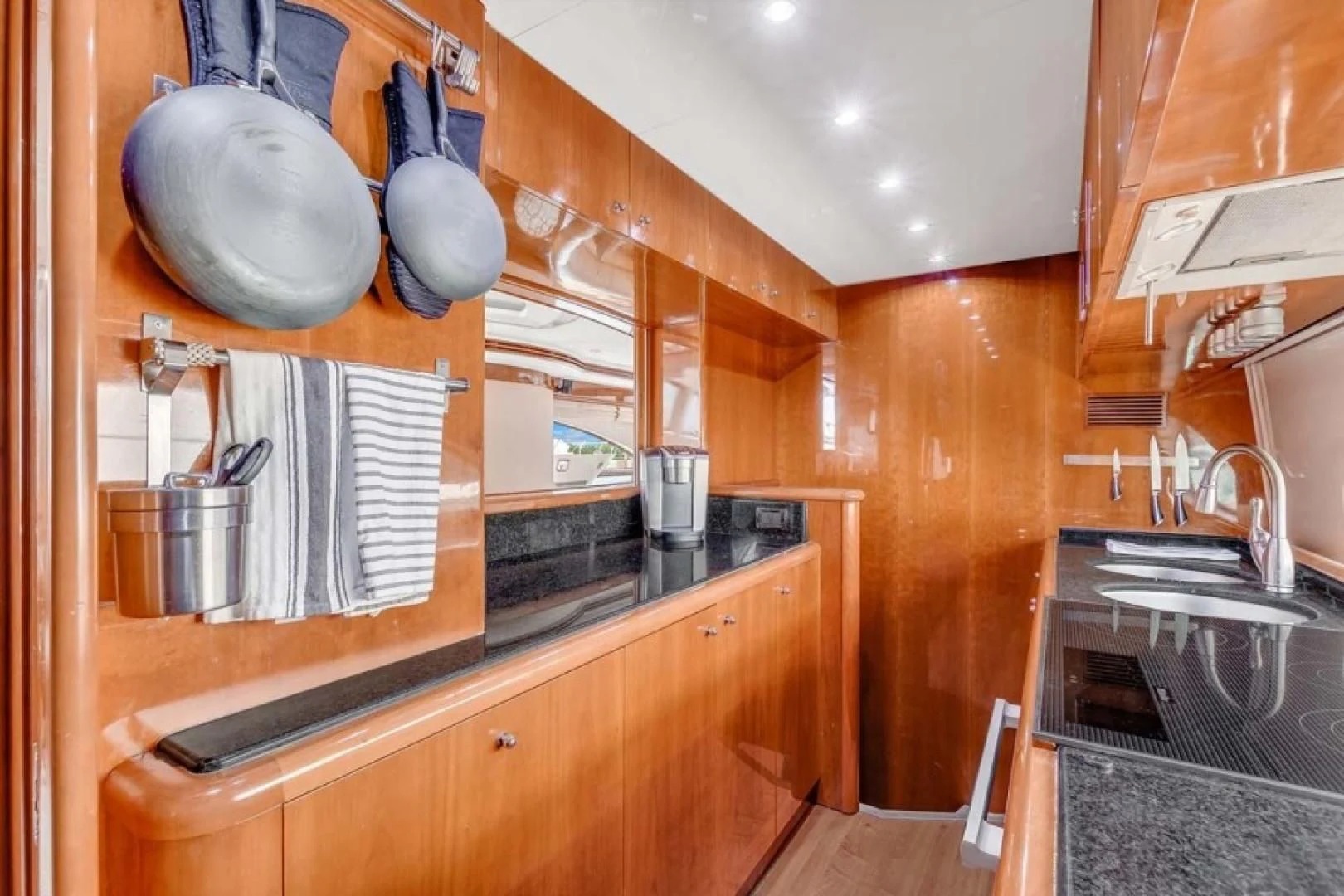 a kitchen with wooden cabinets aboard THE CURE Yacht for Sale