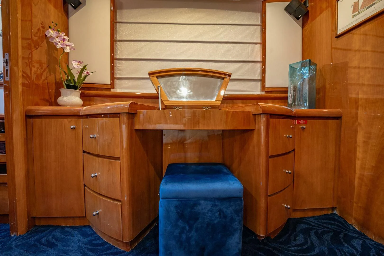a wooden cabinet with a mirror above it aboard THE CURE Yacht for Sale