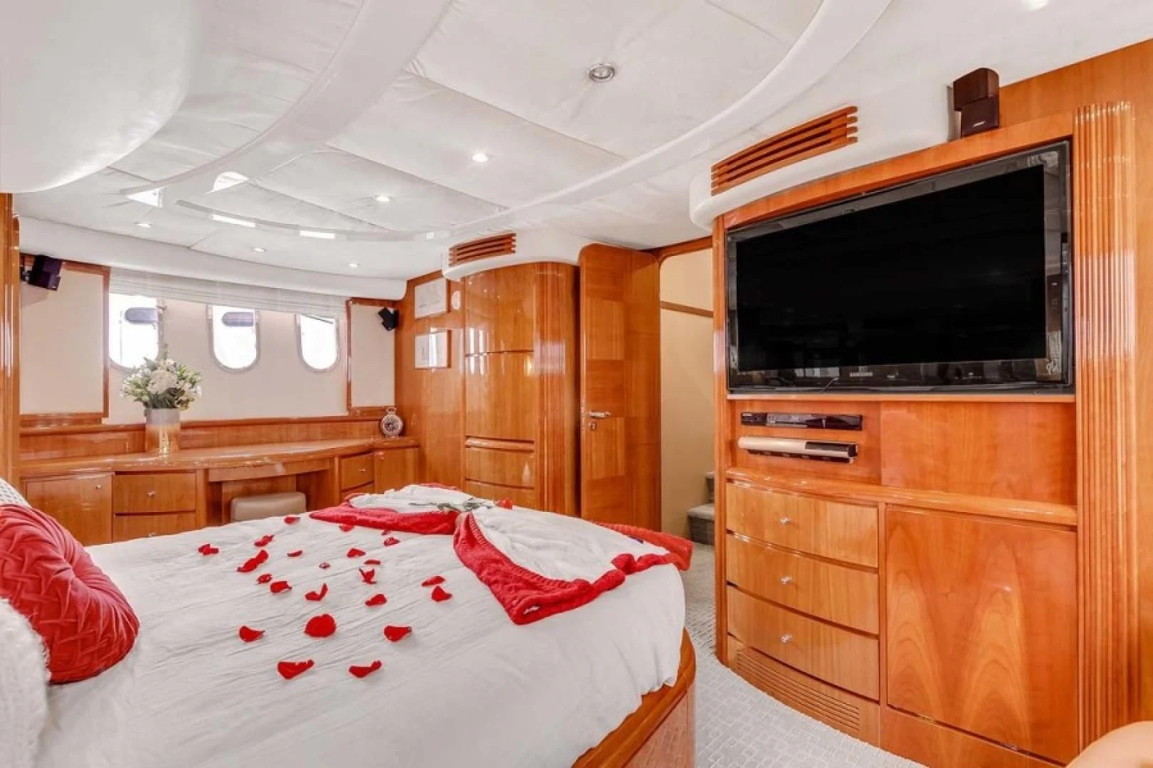 a bedroom with a tv and dresser aboard THE CURE Yacht for Sale