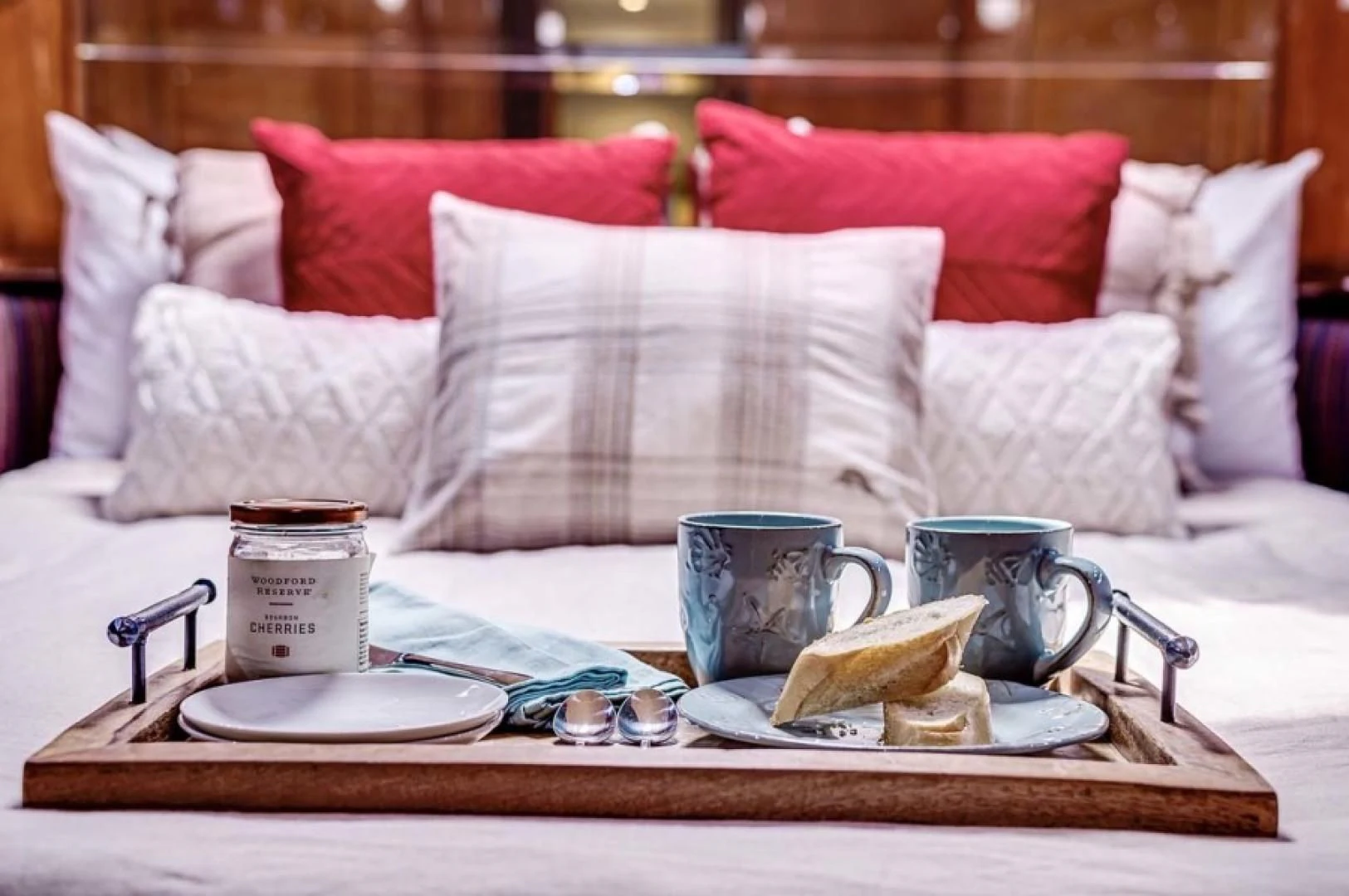 a coffee table with a plate of food and a mug on it aboard THE CURE Yacht for Sale