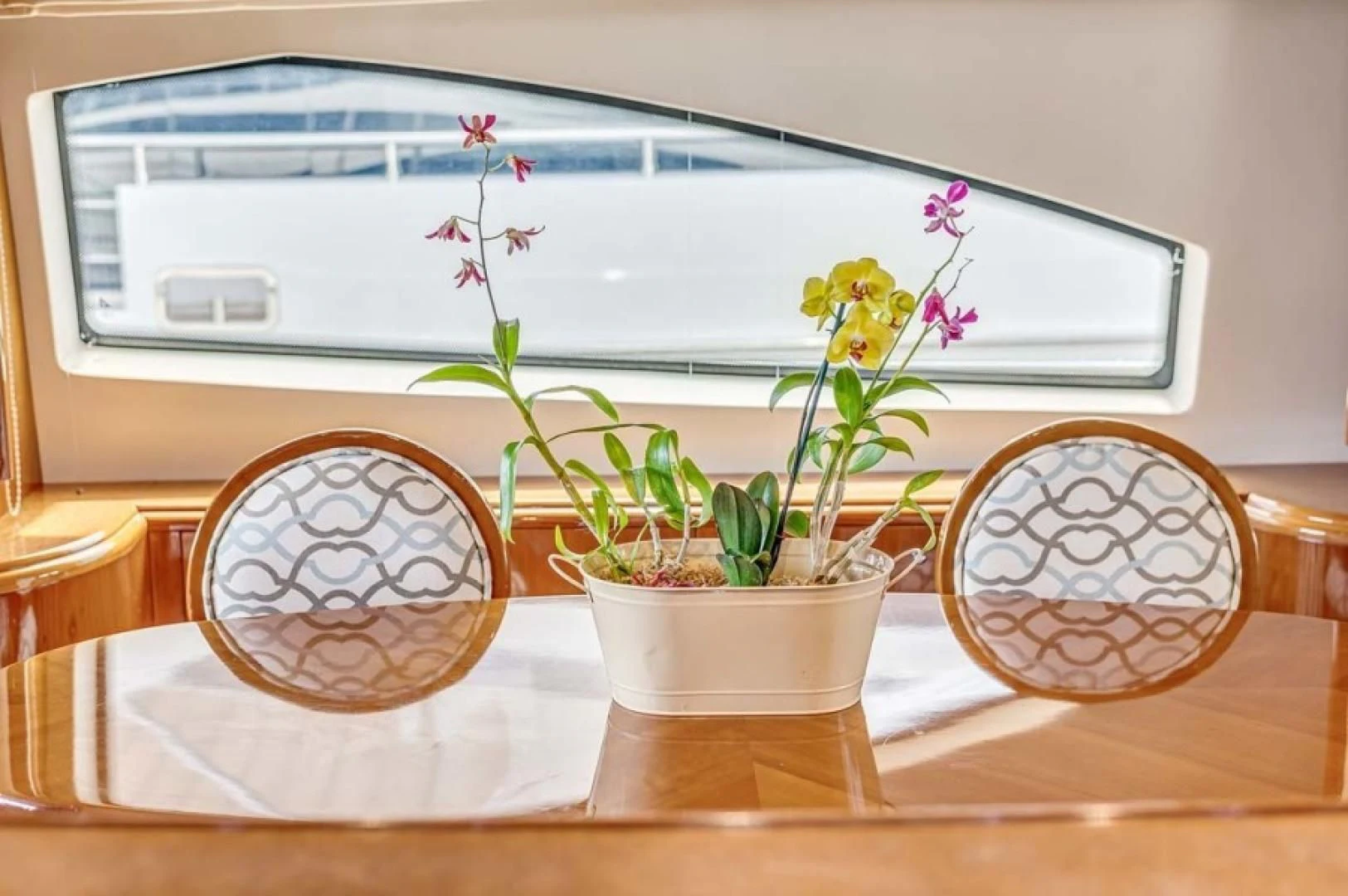 a plant in a pot on a table aboard THE CURE Yacht for Sale
