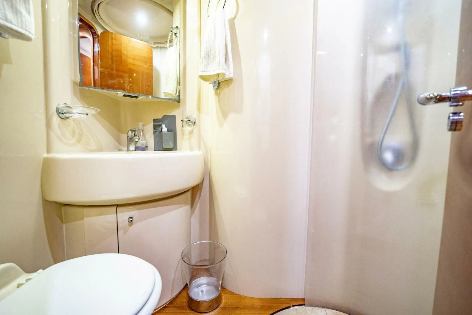 a bathroom with a sink toilet and shower aboard THE CURE Yacht for Sale