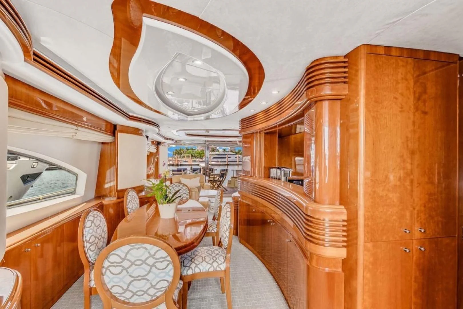 a room with tables chairs and a large mirror aboard THE CURE Yacht for Sale