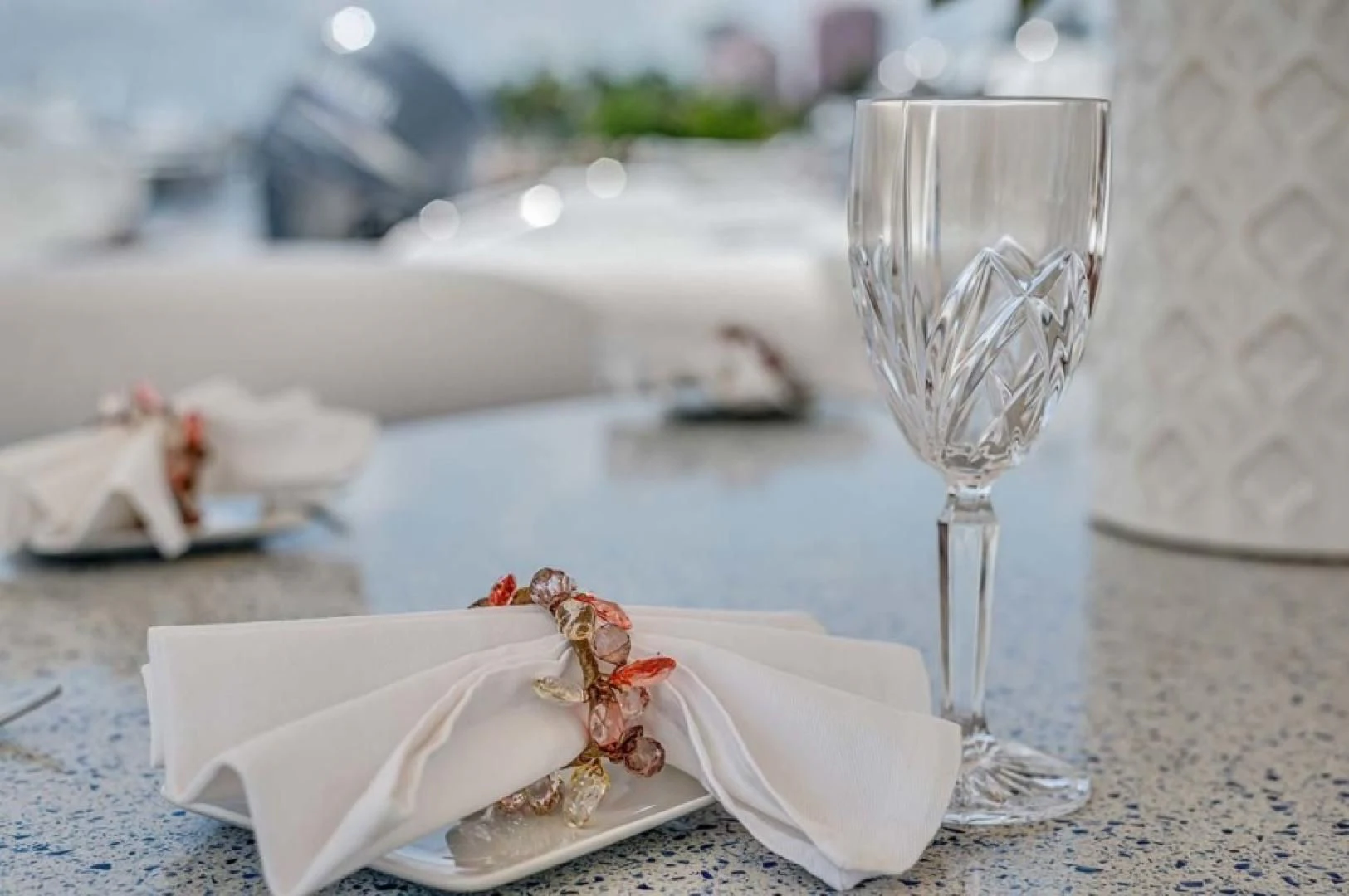 a glass of champagne and a napkin on a table aboard THE CURE Yacht for Sale