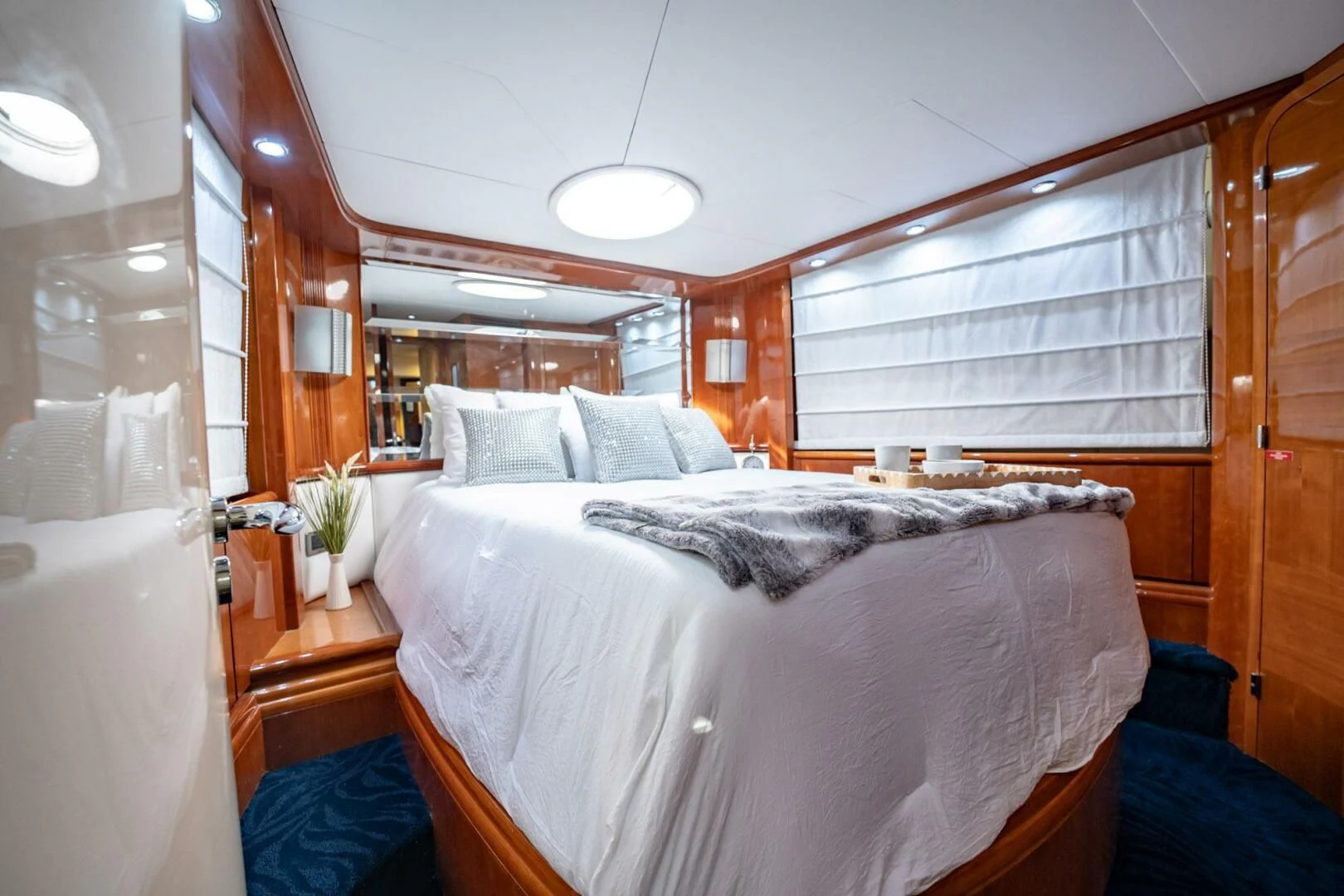 a bedroom with a bed and a window aboard THE CURE Yacht for Sale
