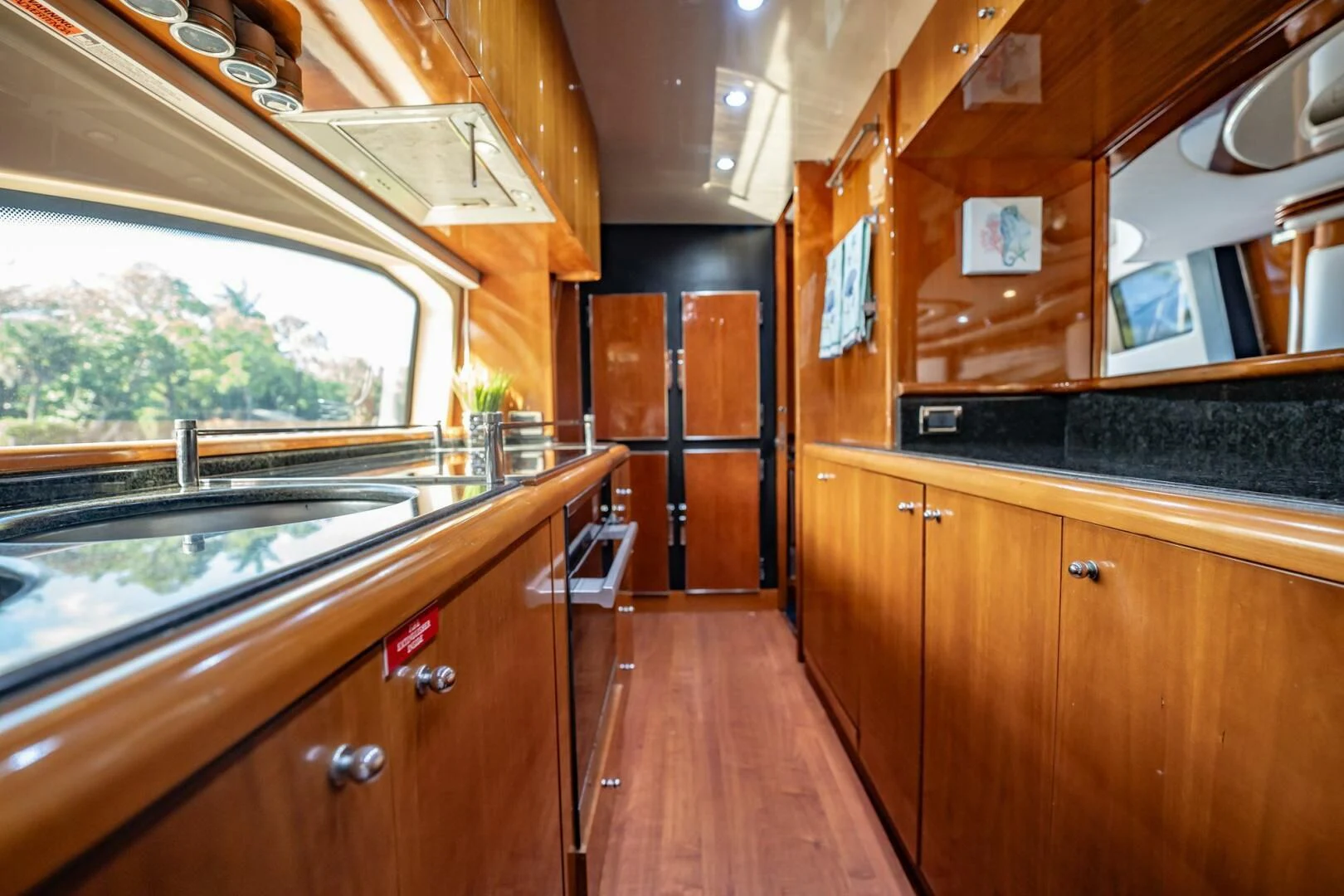 a kitchen with wooden cabinets aboard THE CURE Yacht for Sale