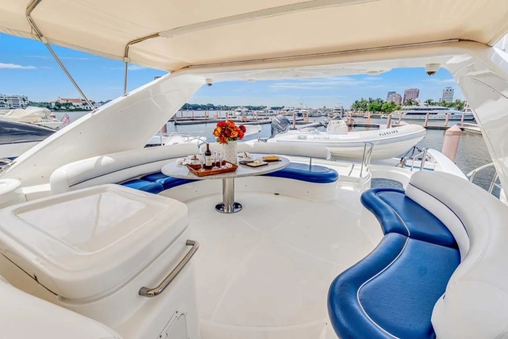 a table with chairs and a vase on it aboard THE CURE Yacht for Sale