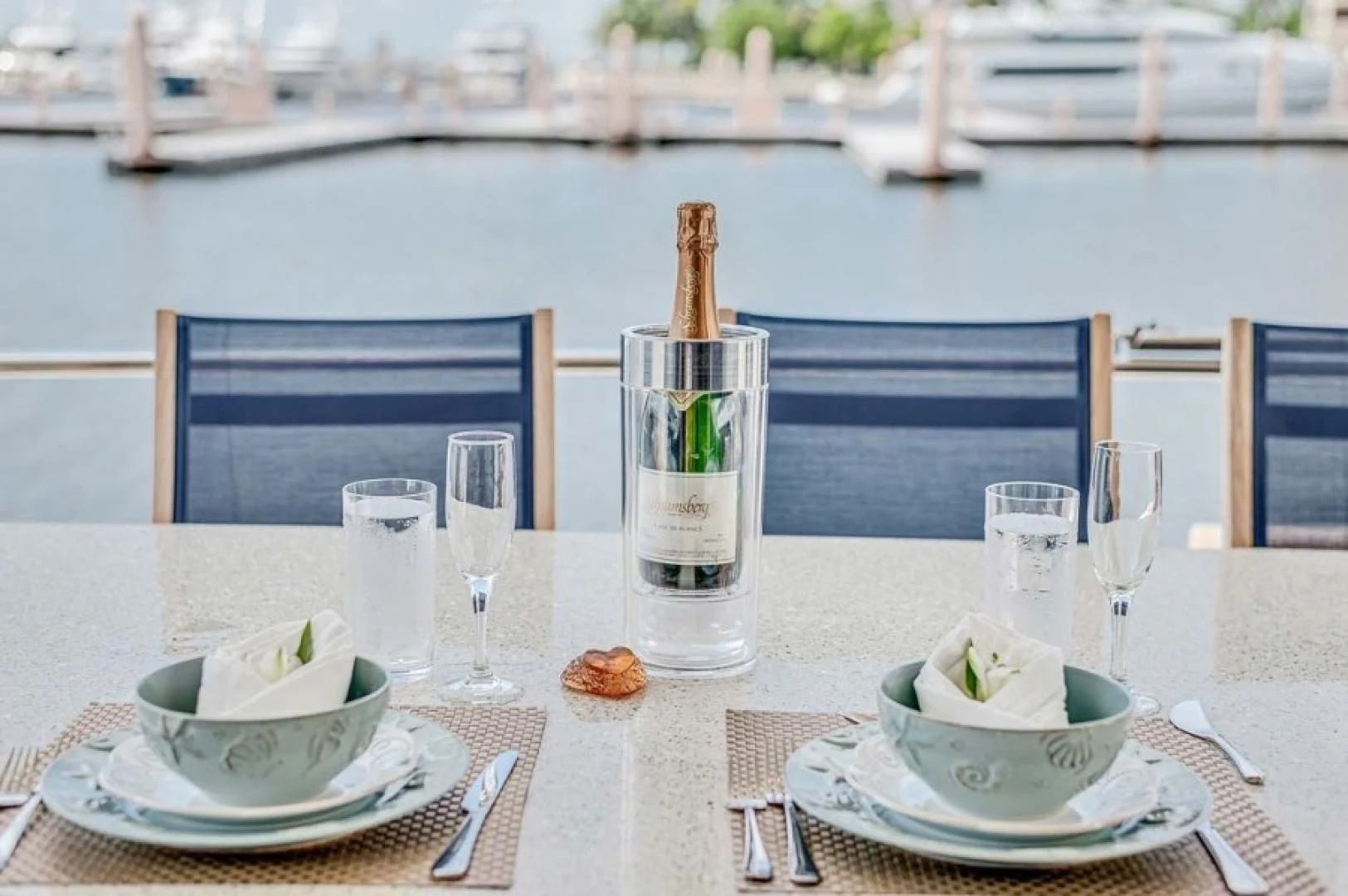 a table with plates and glasses on it aboard THE CURE Yacht for Sale
