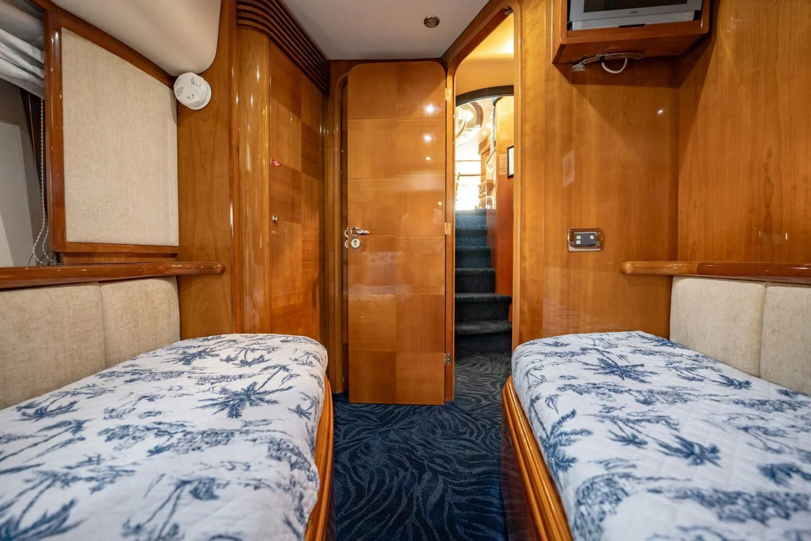 a room with a bed and a door aboard THE CURE Yacht for Sale