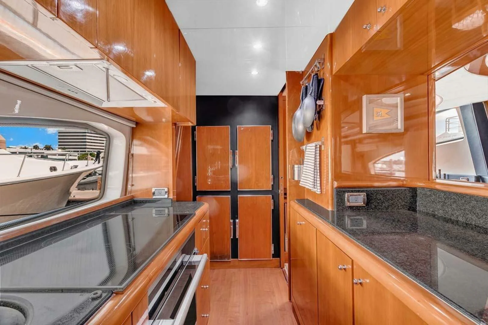 a kitchen with wooden cabinets aboard THE CURE Yacht for Sale