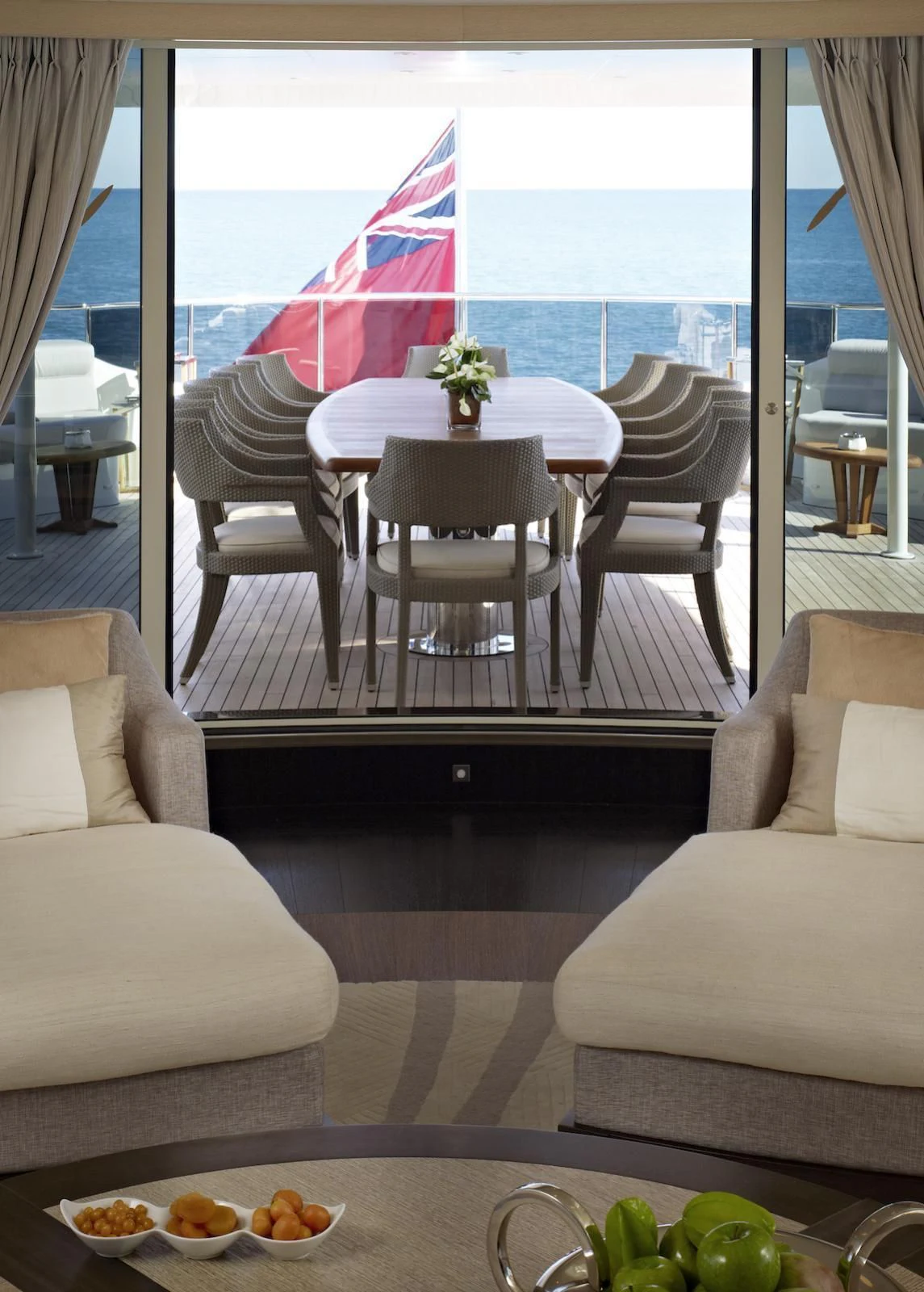 a table with chairs and a flag aboard MY SECRET Yacht for Sale
