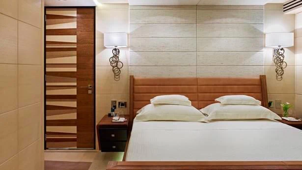 a bed with a wooden headboard aboard MY SECRET Yacht for Sale