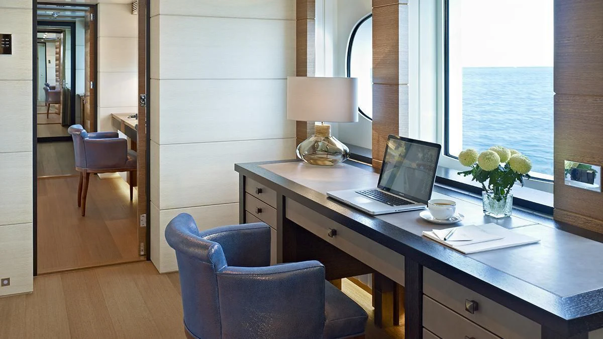 a laptop on a desk aboard MY SECRET Yacht for Sale