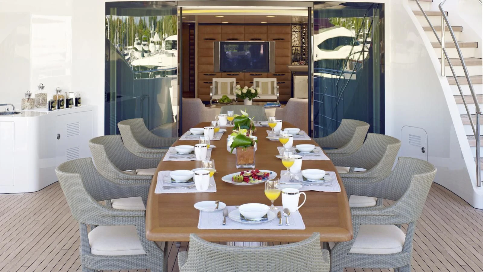 a dining table with chairs and a view of the ocean aboard MY SECRET Yacht for Sale