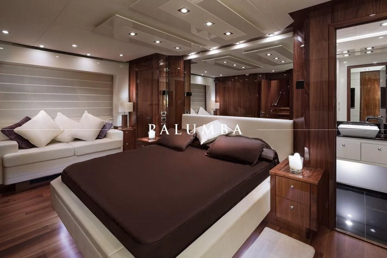 a room with a bed and a couch aboard PALUMBA Yacht for Sale