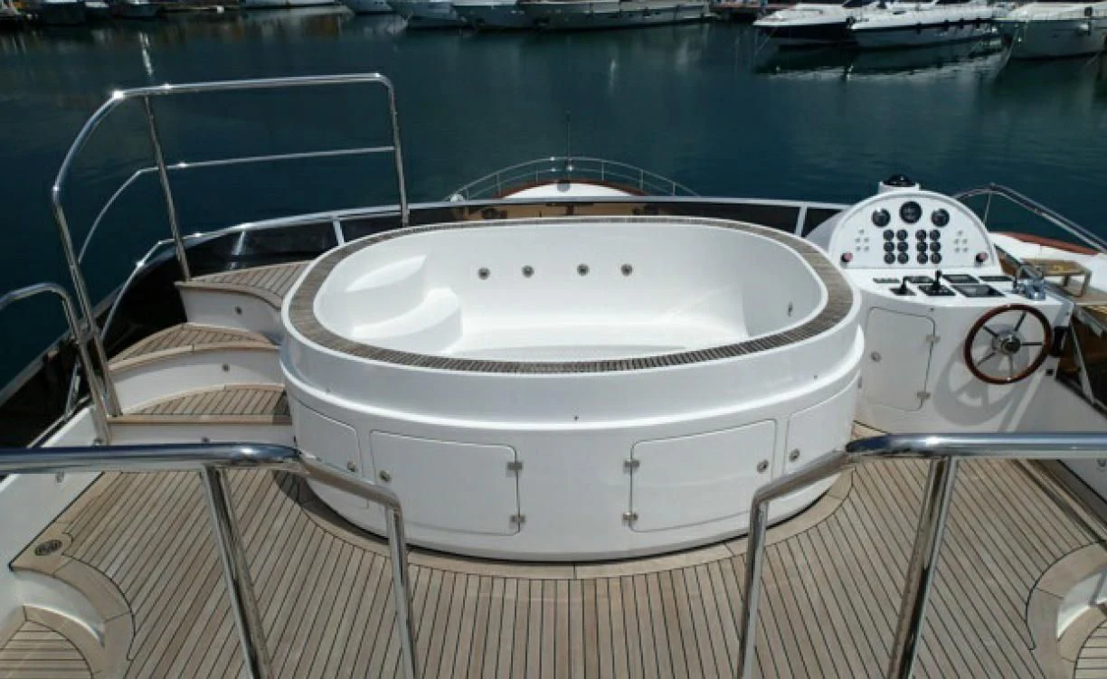 a white boat with a face drawn on the front aboard GOOD VIBES Yacht for Sale
