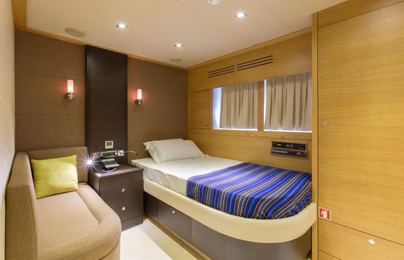 a room with a bed and a chair aboard GOOD VIBES Yacht for Sale