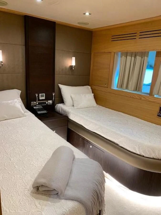 a hotel room with two beds aboard GOOD VIBES Yacht for Sale