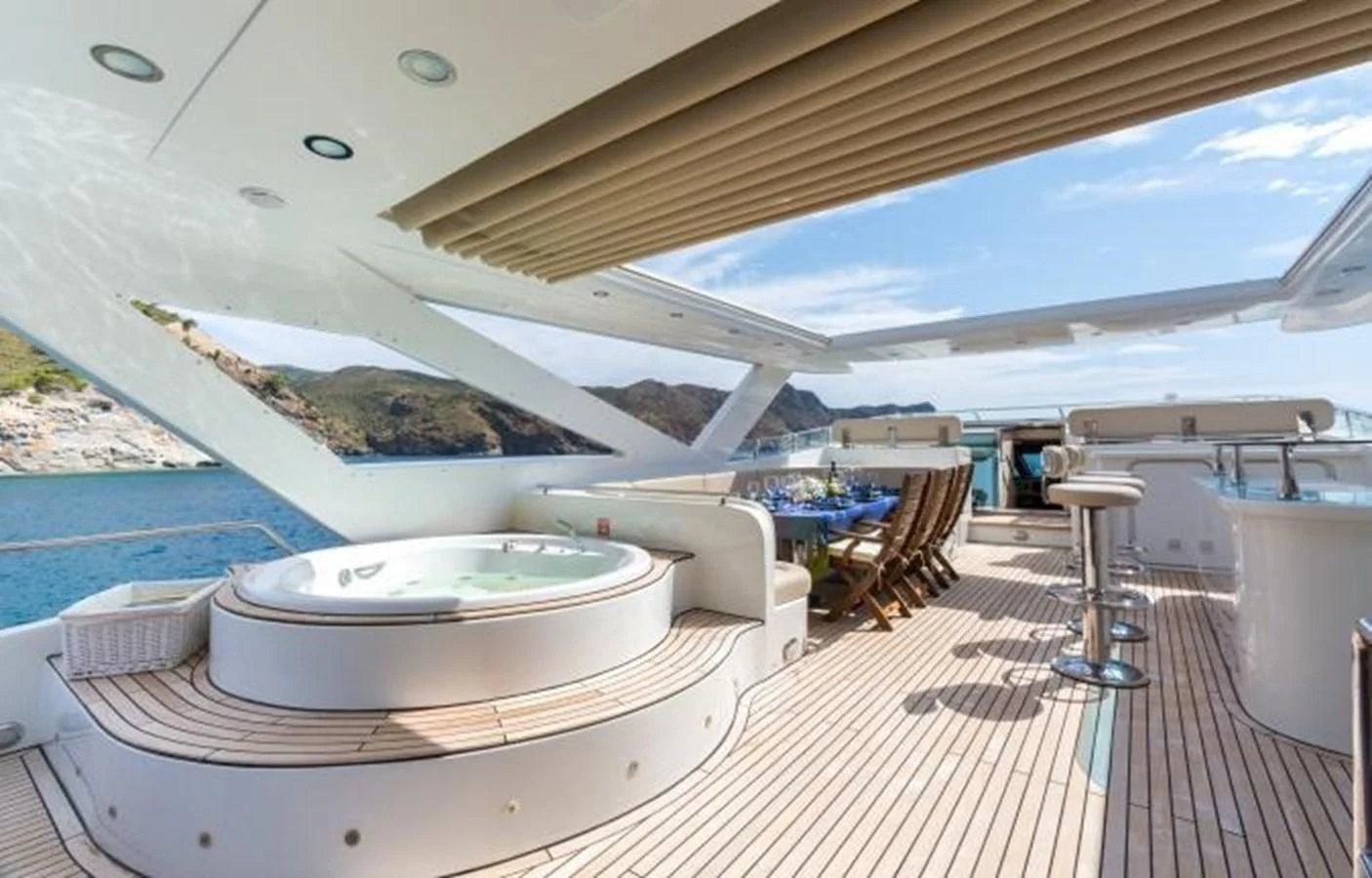 a pool with a table and chairs aboard GOOD VIBES Yacht for Sale