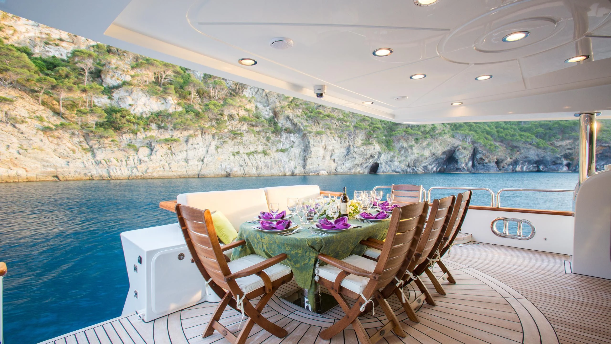 a table and chairs on a patio aboard GOOD VIBES Yacht for Sale