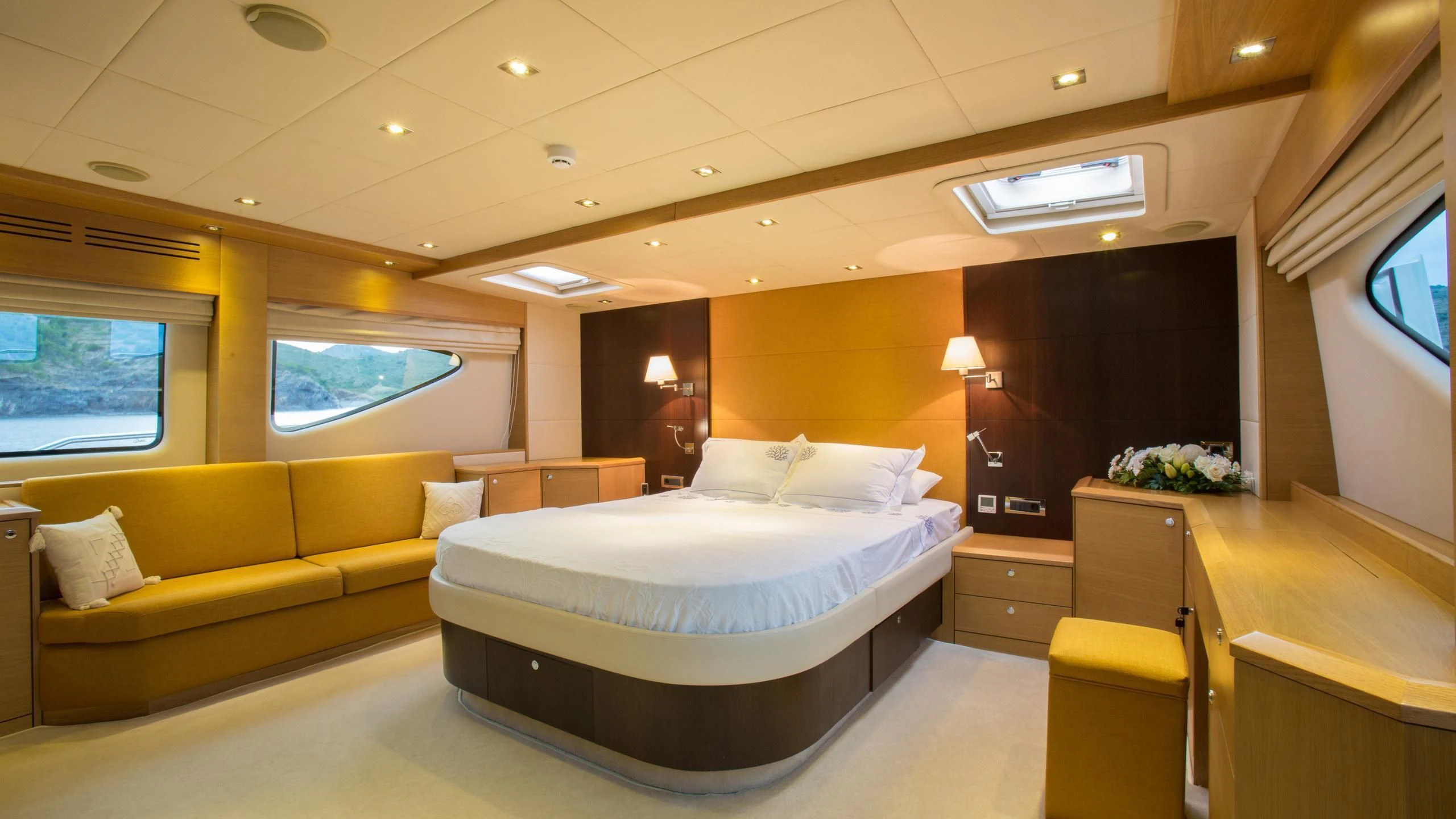 a room with a bed and a couch aboard GOOD VIBES Yacht for Sale