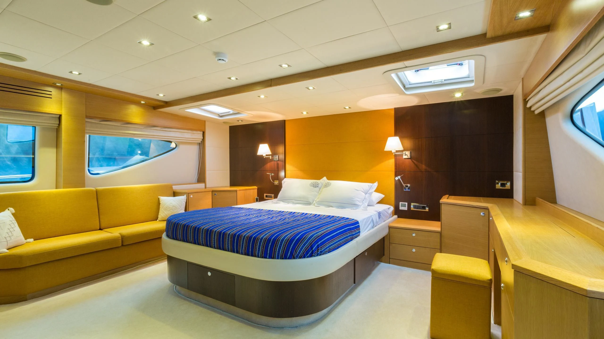 a room with a bed and a couch aboard GOOD VIBES Yacht for Sale