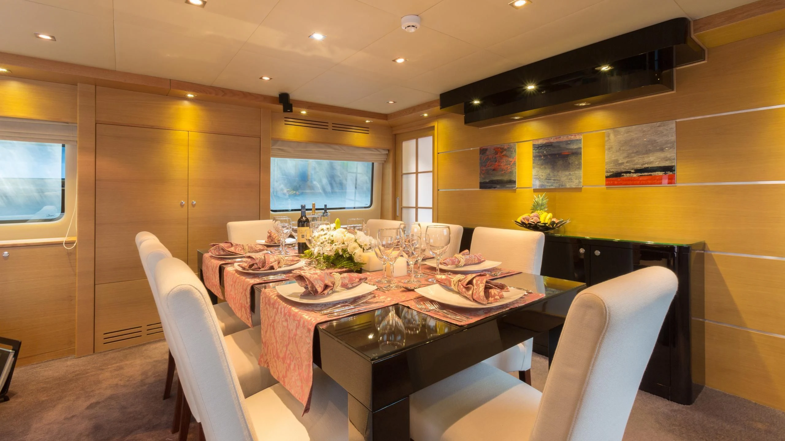a dining room with a table and chairs aboard GOOD VIBES Yacht for Sale