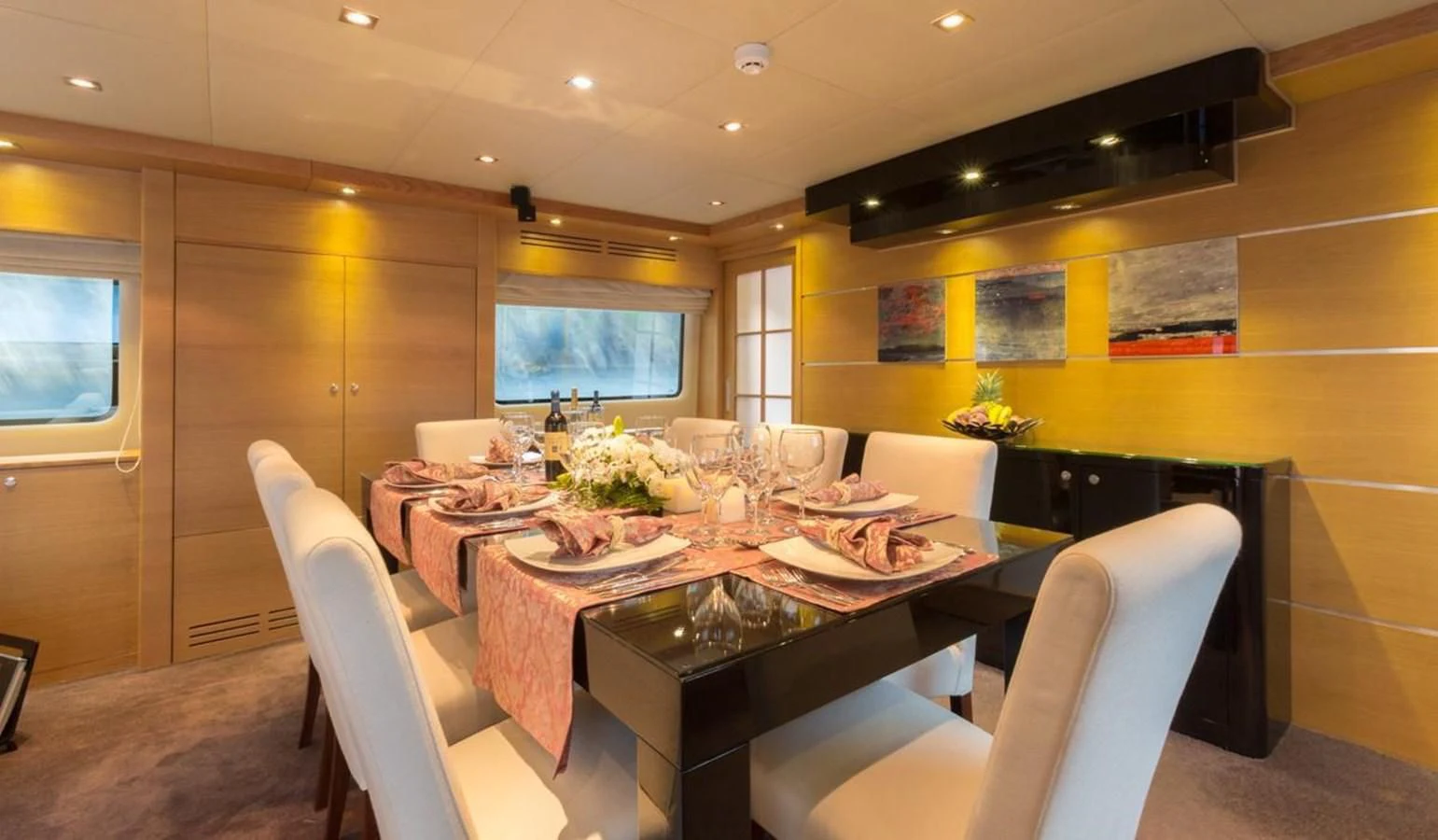 a dining room with a table and chairs aboard GOOD VIBES Yacht for Sale