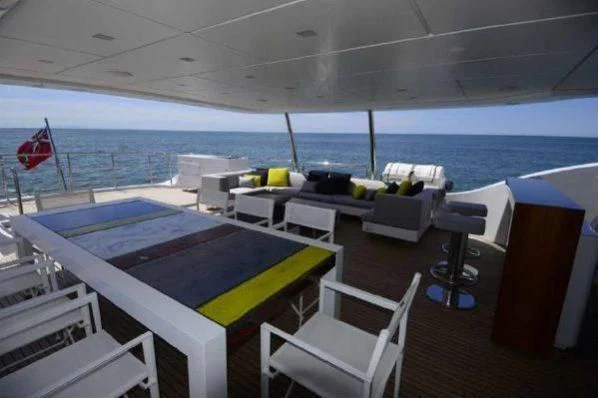 a deck with a pool and chairs aboard GOOD VIBES Yacht for Sale