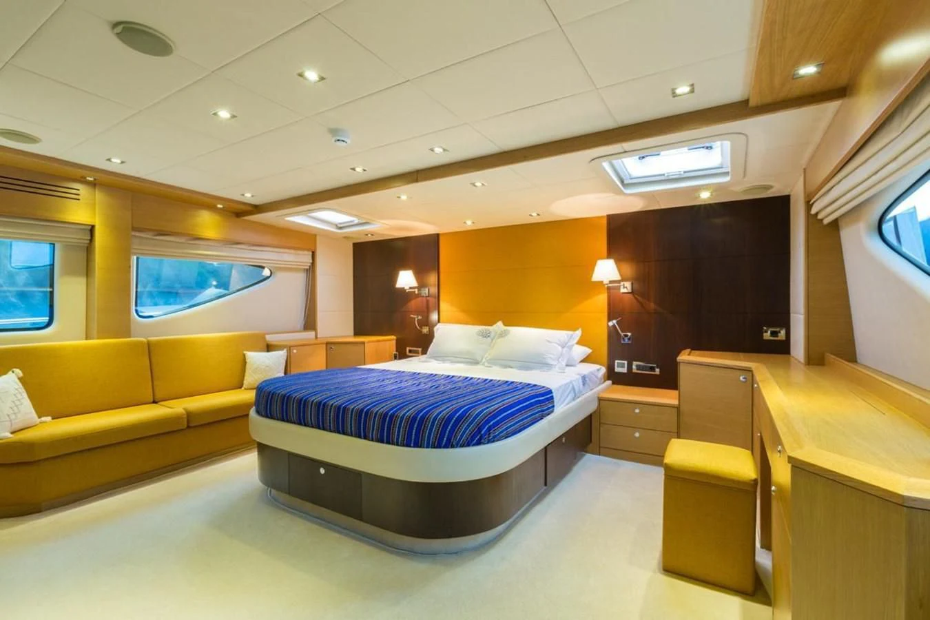 a hotel room with a bed and a couch aboard GOOD VIBES Yacht for Sale