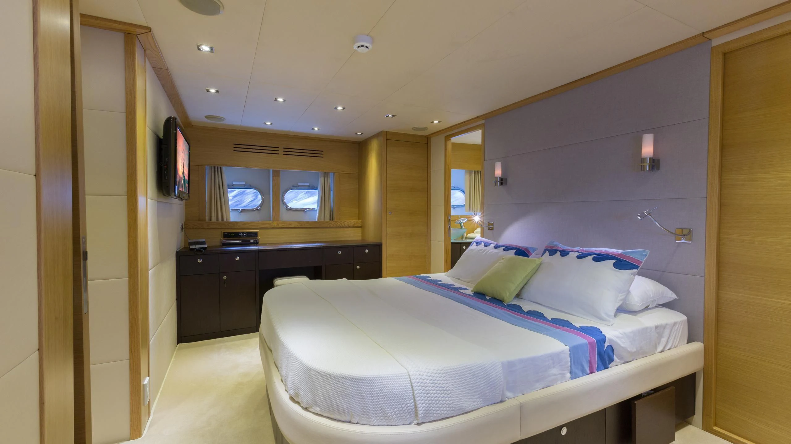 a bedroom with a bed and a desk aboard GOOD VIBES Yacht for Sale