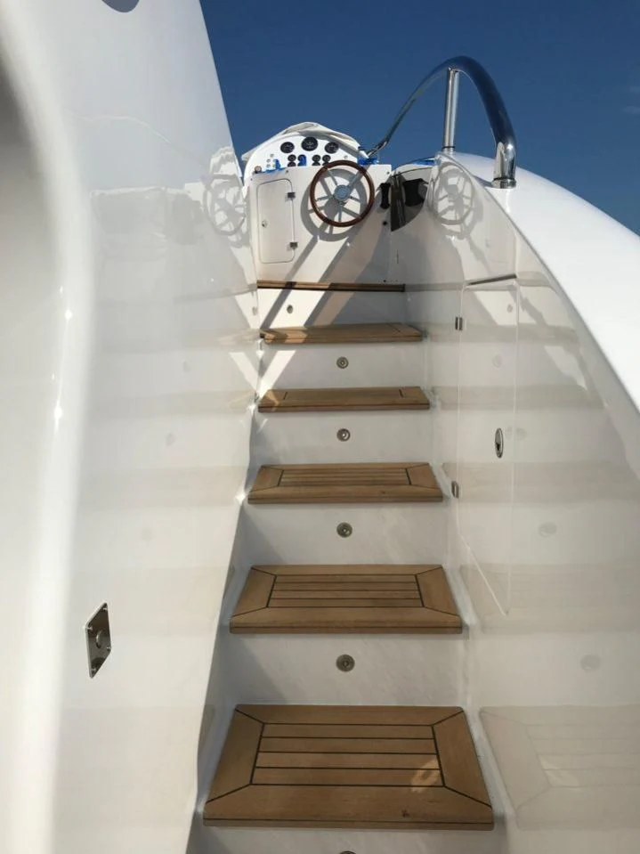 a white and black robot with a metal frame on it aboard GOOD VIBES Yacht for Sale