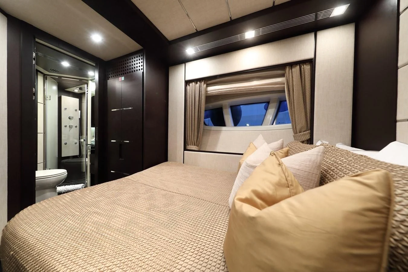 a hotel room with a bed and a large mirror aboard PATRONESS Yacht for Sale