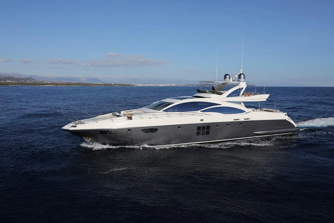 a white yacht on the water aboard PATRONESS Yacht for Sale