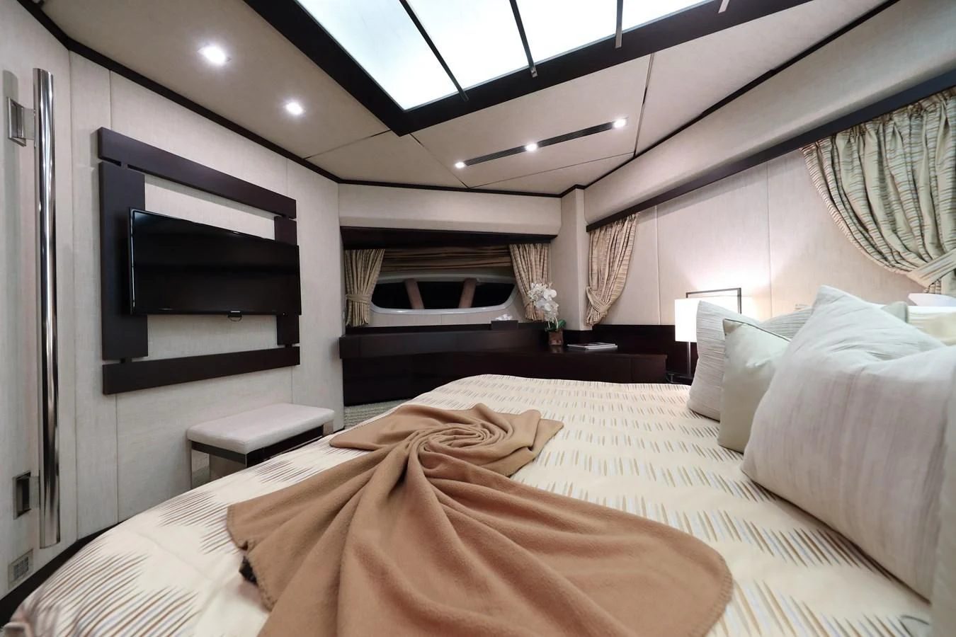 a bedroom with a bed and a tv on the wall aboard PATRONESS Yacht for Sale