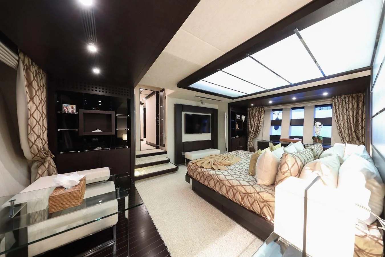 a bedroom with a bed and a fireplace aboard PATRONESS Yacht for Sale
