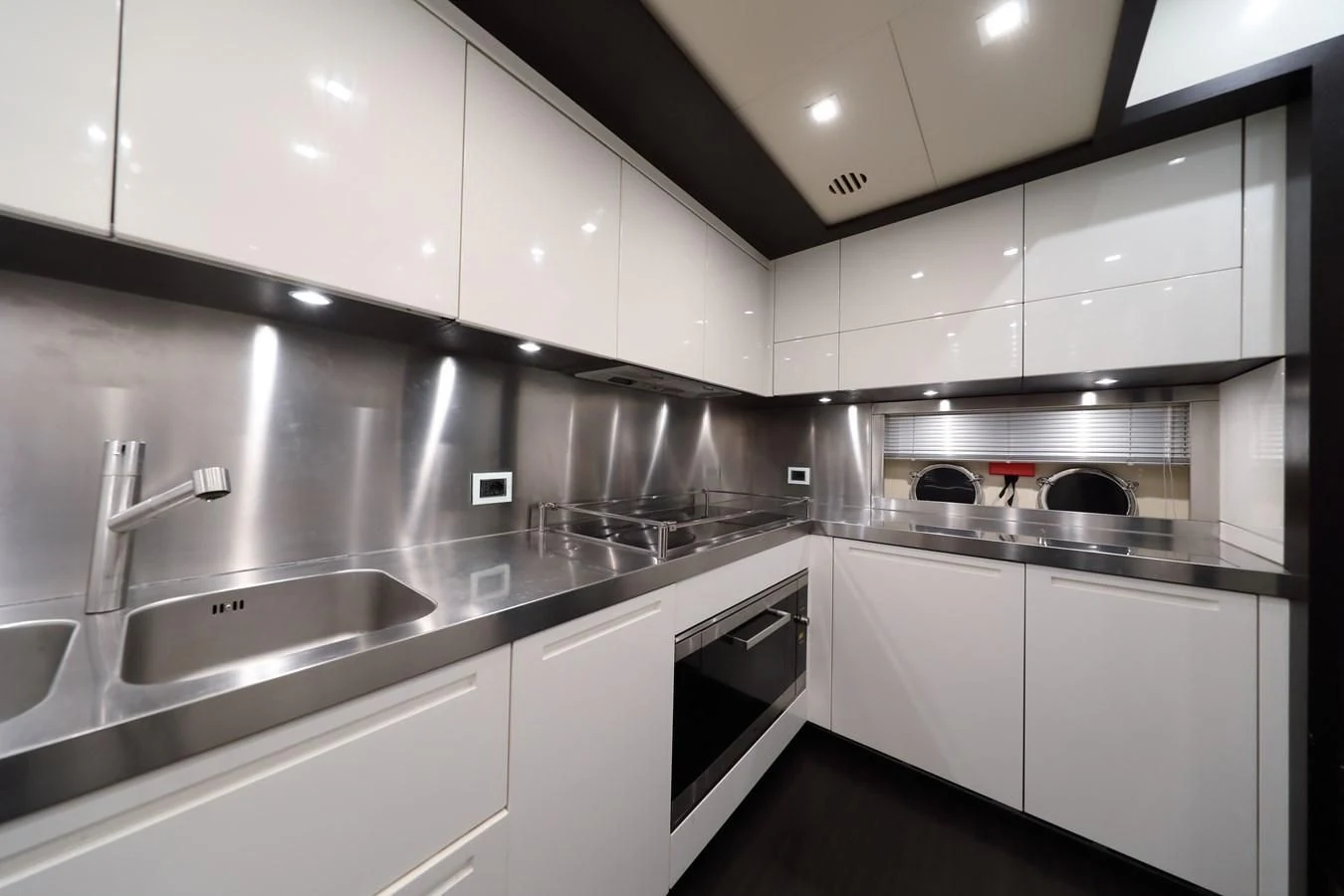 a kitchen with white cabinets aboard PATRONESS Yacht for Sale