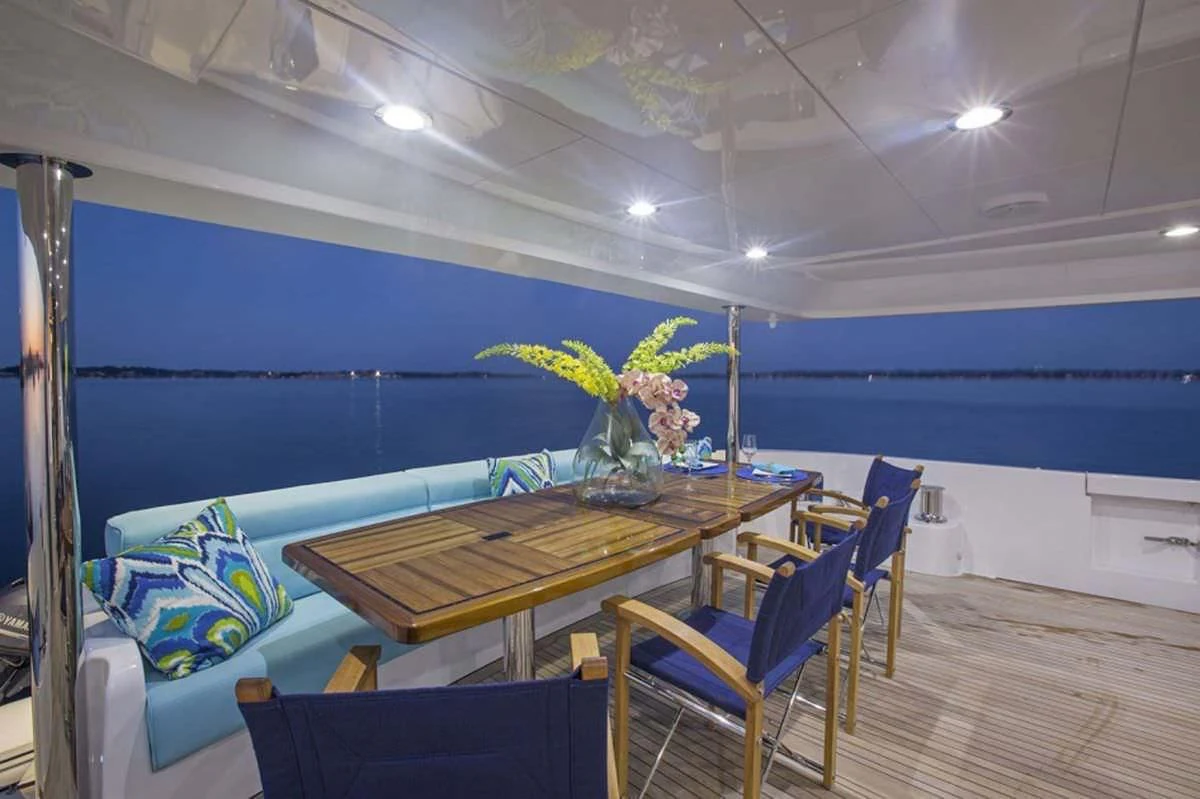 a room with a table and chairs aboard LADY CARMEN Yacht for Sale