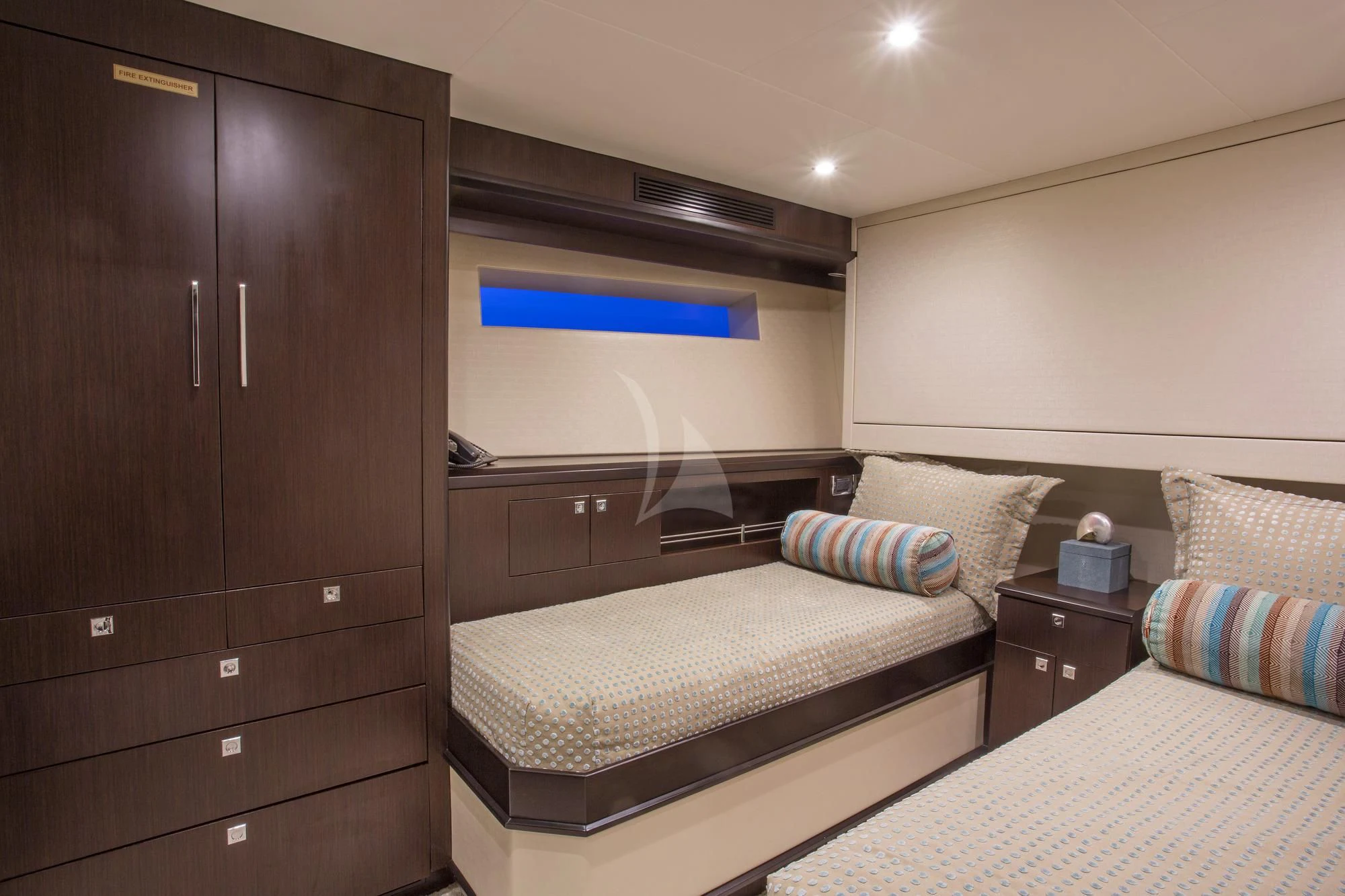a bedroom with a bed and a dresser aboard LADY CARMEN Yacht for Sale