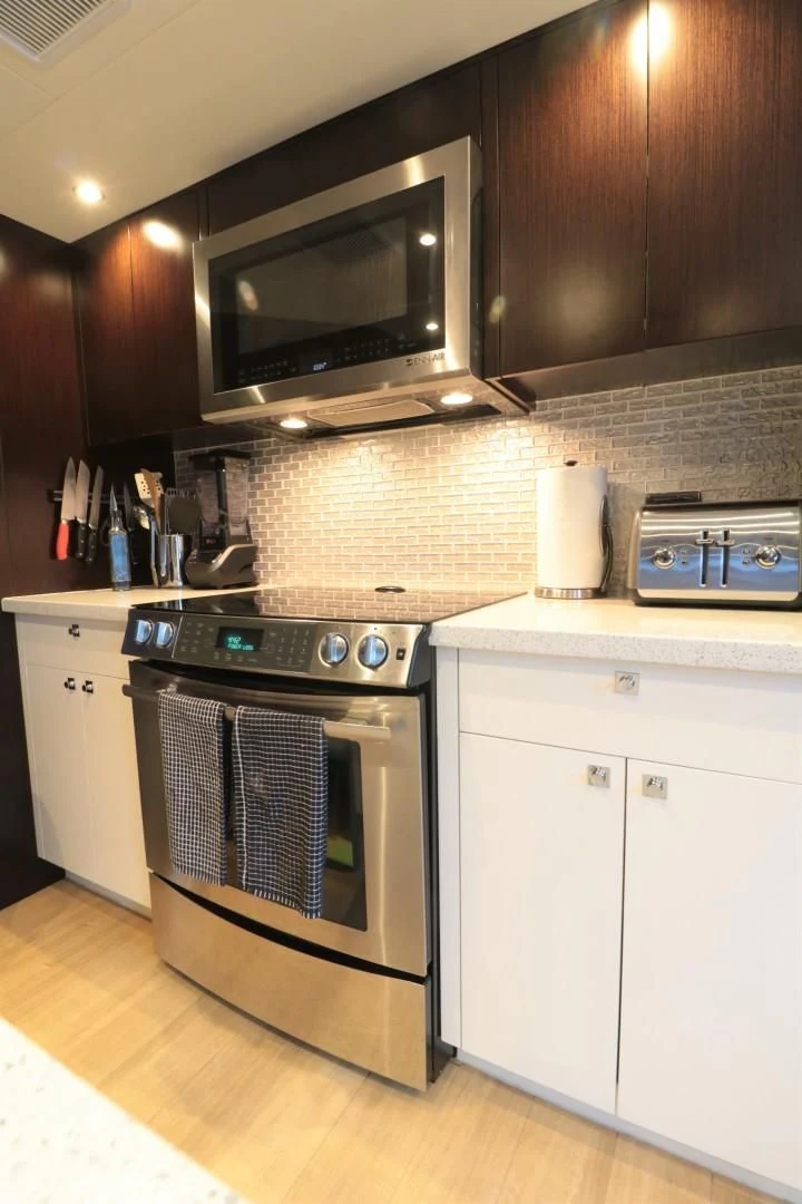 a kitchen with a stove and microwave aboard LADY CARMEN Yacht for Sale