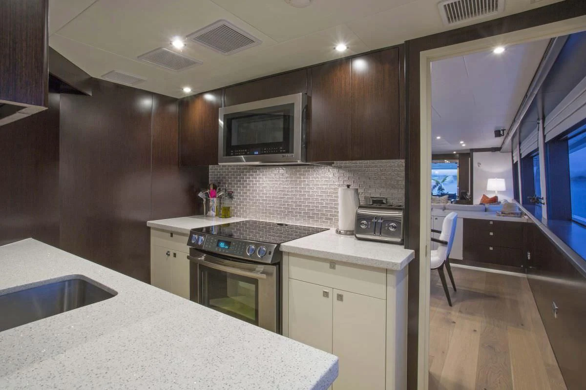 a kitchen with a countertop sink and a microwave aboard LADY CARMEN Yacht for Sale