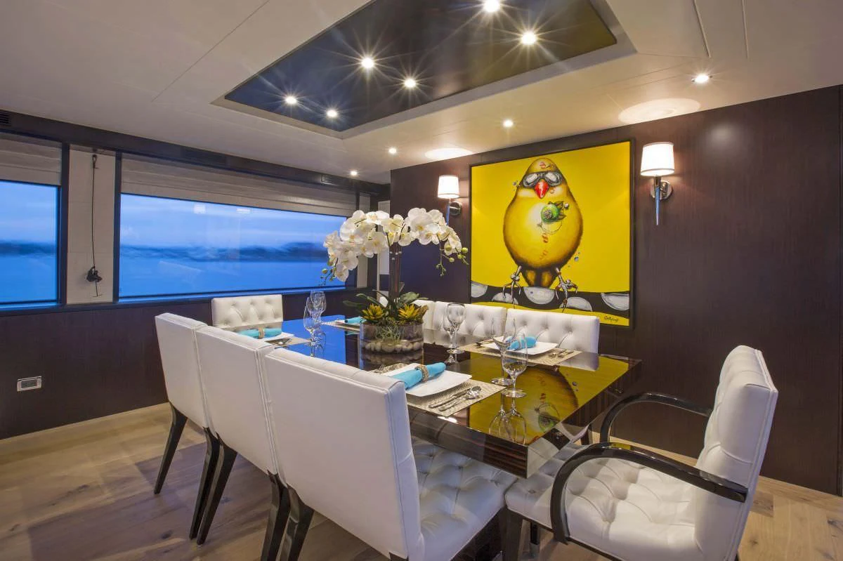 a dining room with a large painting aboard LADY CARMEN Yacht for Sale