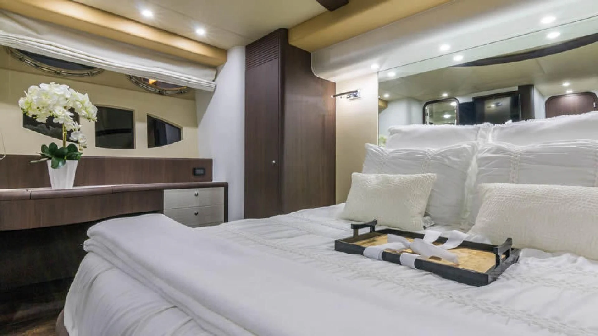 a bed with white sheets and pillows aboard NEXT Yacht for Sale